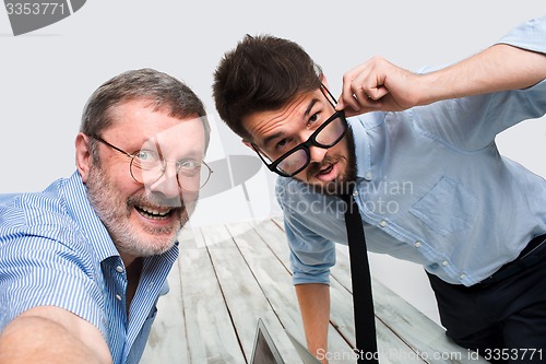 Image of Two colleagues  taking the picture to them self sitting in  office