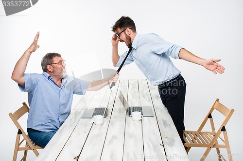 Image of Business conflict. The two men expressing negativity while one man grabbing the necktie of her opponent