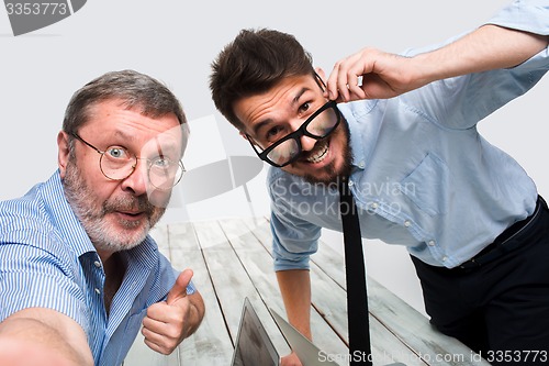 Image of Two colleagues  taking the picture to them self sitting in  office