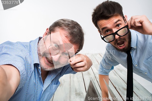 Image of Two colleagues  taking the picture to them self sitting in  office