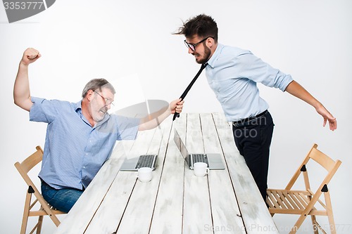 Image of Business conflict. The two men expressing negativity while one man grabbing the necktie of her opponent