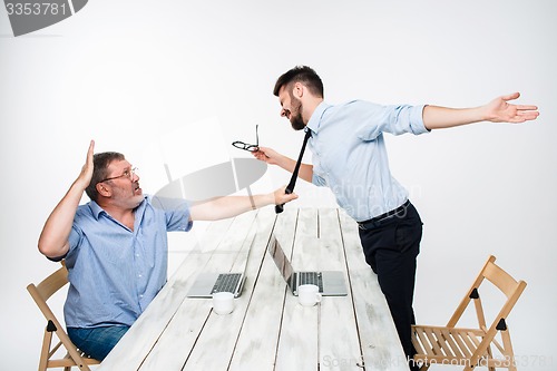 Image of Business conflict. The two men expressing negativity while one man grabbing the necktie of her opponent