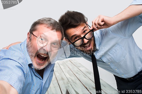 Image of Two colleagues  taking the picture to them self sitting in  office