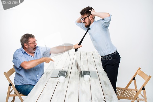 Image of Business conflict. The two men expressing negativity while one man grabbing the necktie of her opponent