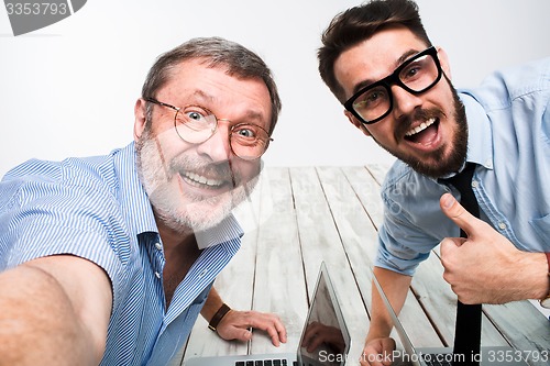 Image of Two colleagues  taking the picture to them self sitting in  office