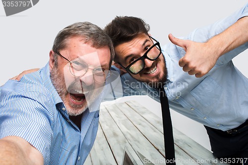 Image of Two colleagues  taking the picture to them self sitting in  office
