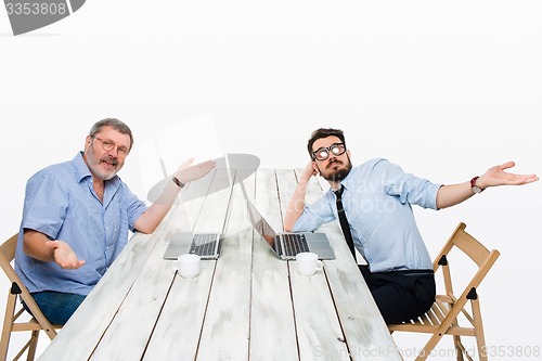 Image of The two colleagues working together at office on white background