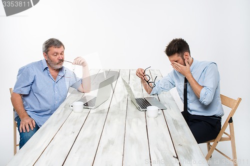 Image of The two colleagues working together at office on white background