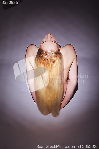 Image of High Angle View of a Seated Bare Blond Young Woman