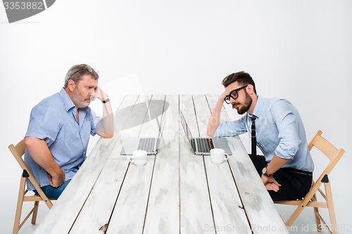 Image of The two colleagues working together at office on white background