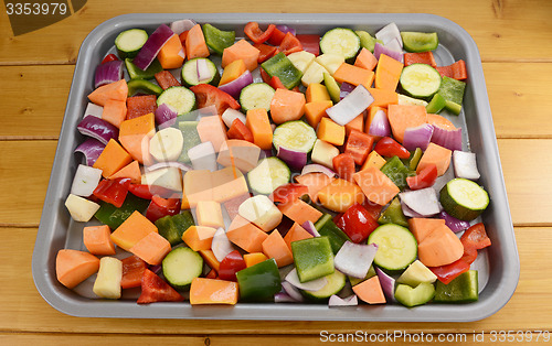 Image of Chopped raw vegetables seasoned and drizzled with oil