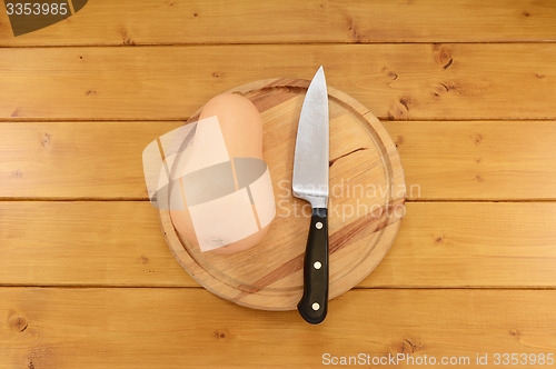 Image of Butternut squash with a knife on a chopping board