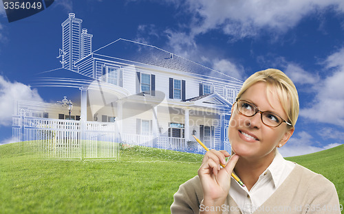 Image of Smiling Woman Holding Pencil Looking to Ghosted House Drawing Be