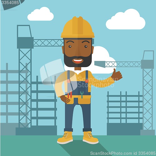 Image of Black man standing infront of construction crane tower.