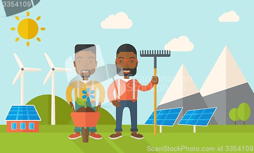 Image of Two black men with wheelbarrow and rake.