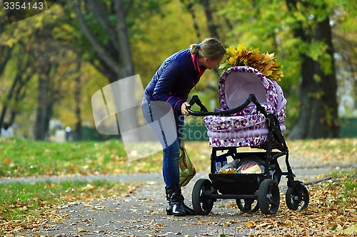 Image of perambulator standing in the autumn park