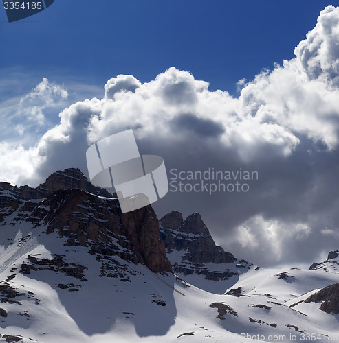 Image of Snowy mountains in nice day before storm