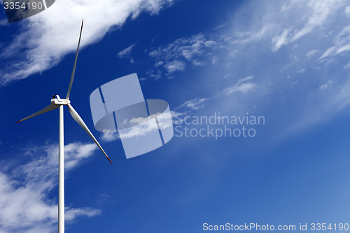 Image of Wind turbine and blue sky with clouds