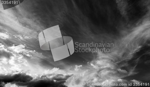 Image of Black and white sky with clouds in wind day