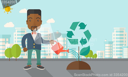 Image of Man watering a recycling tree.