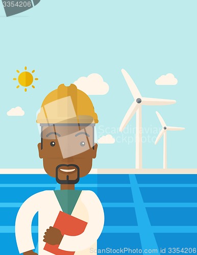 Image of Black man in solar panel and windmills.