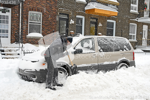 Image of Man shovelling and removing snow