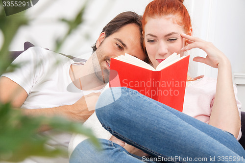 Image of Sweet Young Couple Reading a Book Together