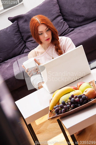 Image of Young Woman Using Laptop In the Living Room