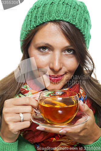 Image of Attractive woman warming up with a cup of hot tea