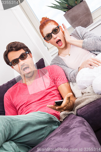 Image of Couple Wearing 3D Glasses with Shocked Faces