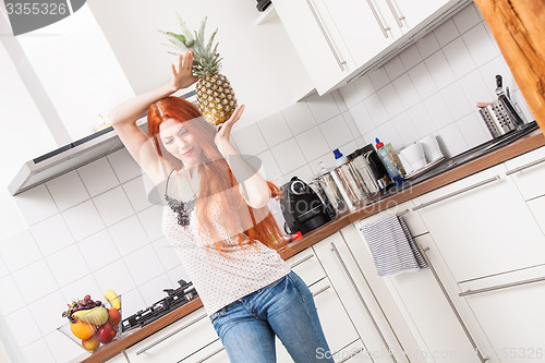Image of Happy Woman Using a Pineapple as Microphone