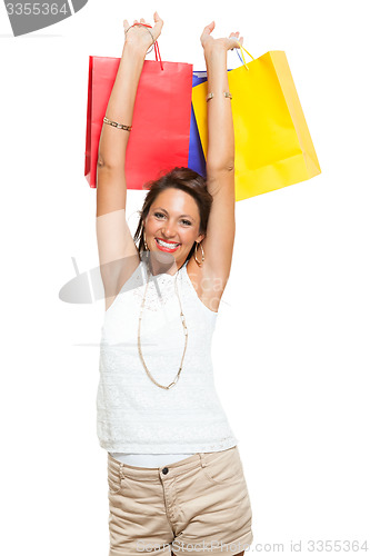 Image of Happy Woman Raising Colored Shopping Bag