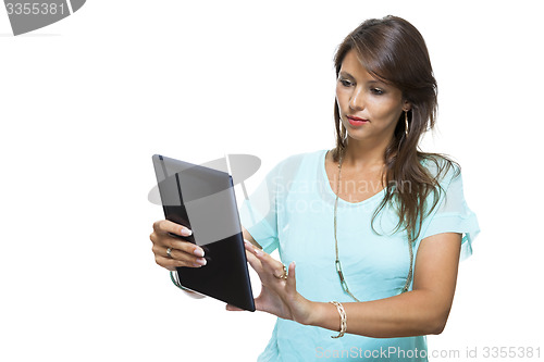 Image of Pretty Woman Browsing at her Tablet Computer