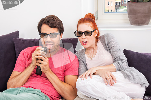 Image of Couple Wearing 3D Glasses with Shocked Faces