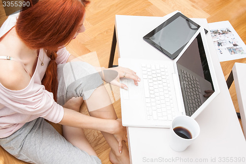 Image of Young Woman Using Laptop In the Living Room