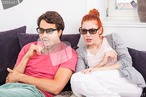 Image of Couple Wearing 3D Glasses with Shocked Faces