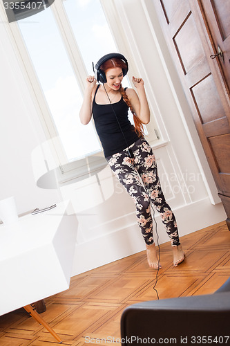 Image of Woman Dancing While Listening Music on Headphone