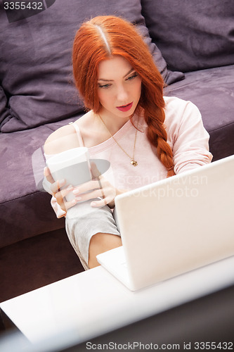 Image of Young Woman Using Laptop In the Living Room