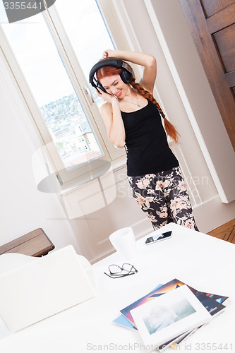 Image of Woman Dancing While Listening Music on Headphone