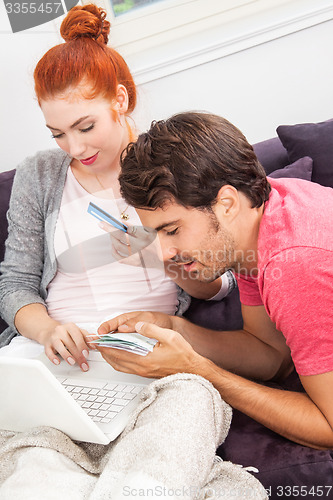 Image of Young Couple Watching a Movie on Laptop Together