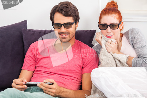 Image of Couple Wearing 3D Glasses with Shocked Faces