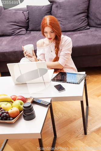 Image of Young Woman Using Laptop In the Living Room