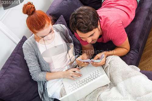 Image of Young Couple Watching a Movie on Laptop Together