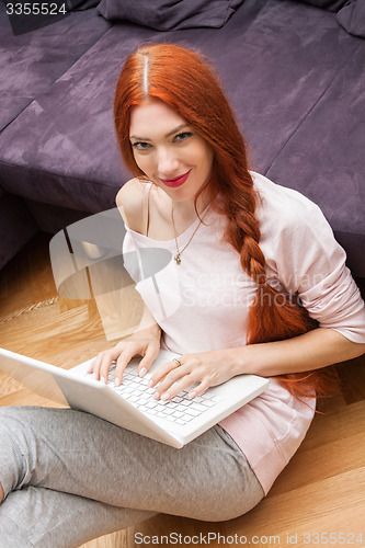 Image of Young Woman Using Laptop In the Living Room