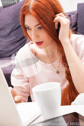 Image of Young Woman Using Laptop In the Living Room