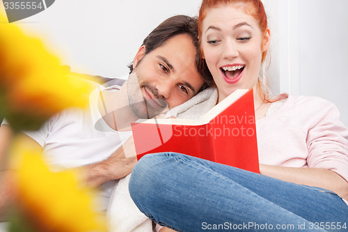 Image of Sweet Young Couple Reading a Book Together