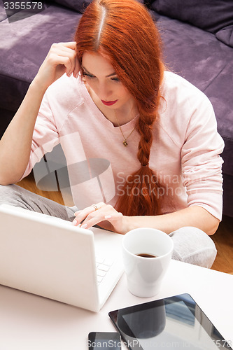 Image of Young Woman Using Laptop In the Living Room