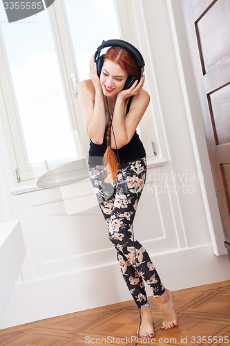 Image of Woman Dancing While Listening Music on Headphone