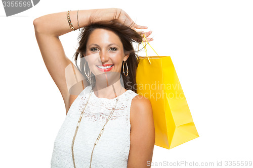 Image of Happy Woman Raising Colored Shopping Bag