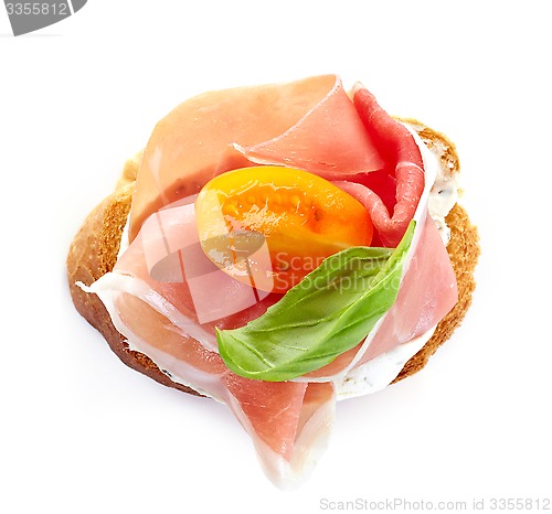 Image of toasted bread with smoked meat and tomato